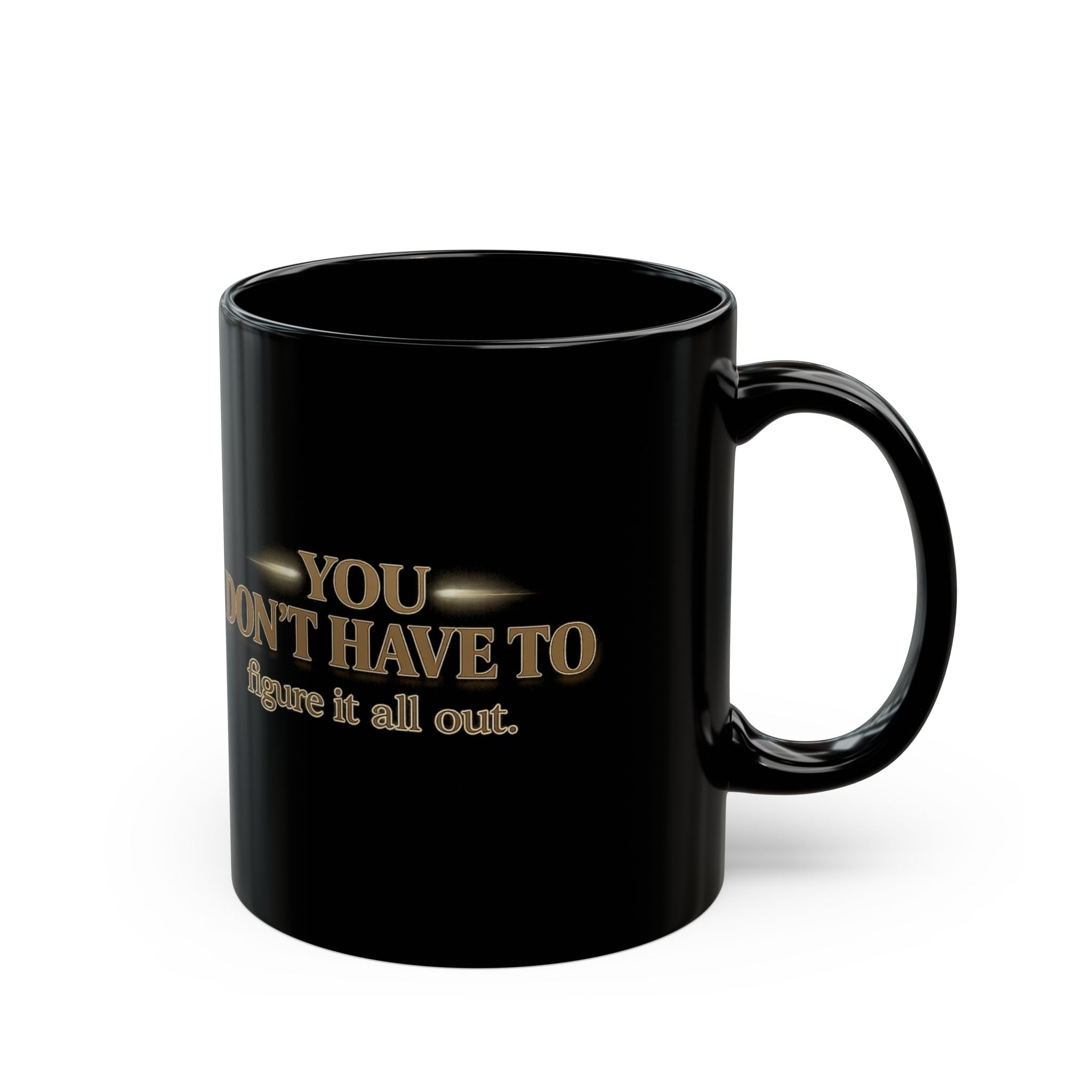 Christian faith coffee mug featuring the phrase 'You Don't Have to Figure It All Out' in gold on a black background.