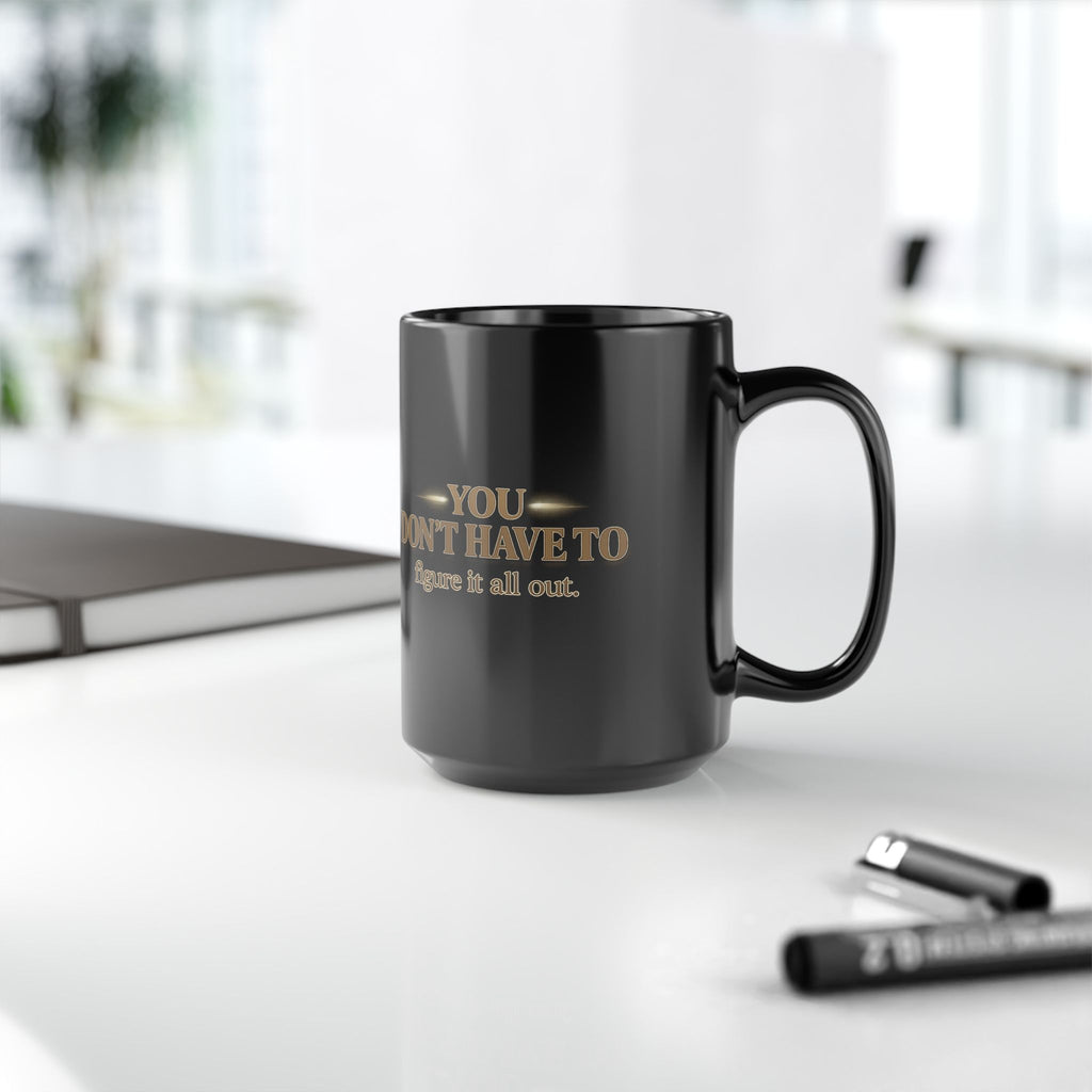 Christian faith coffee mug with text 'You Don't Have to Figure It All Out' on a table.