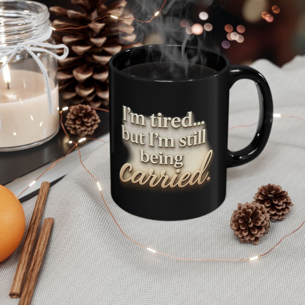 Christian faith encouragement mug with "I'm Tired But Still Being Carried" quote