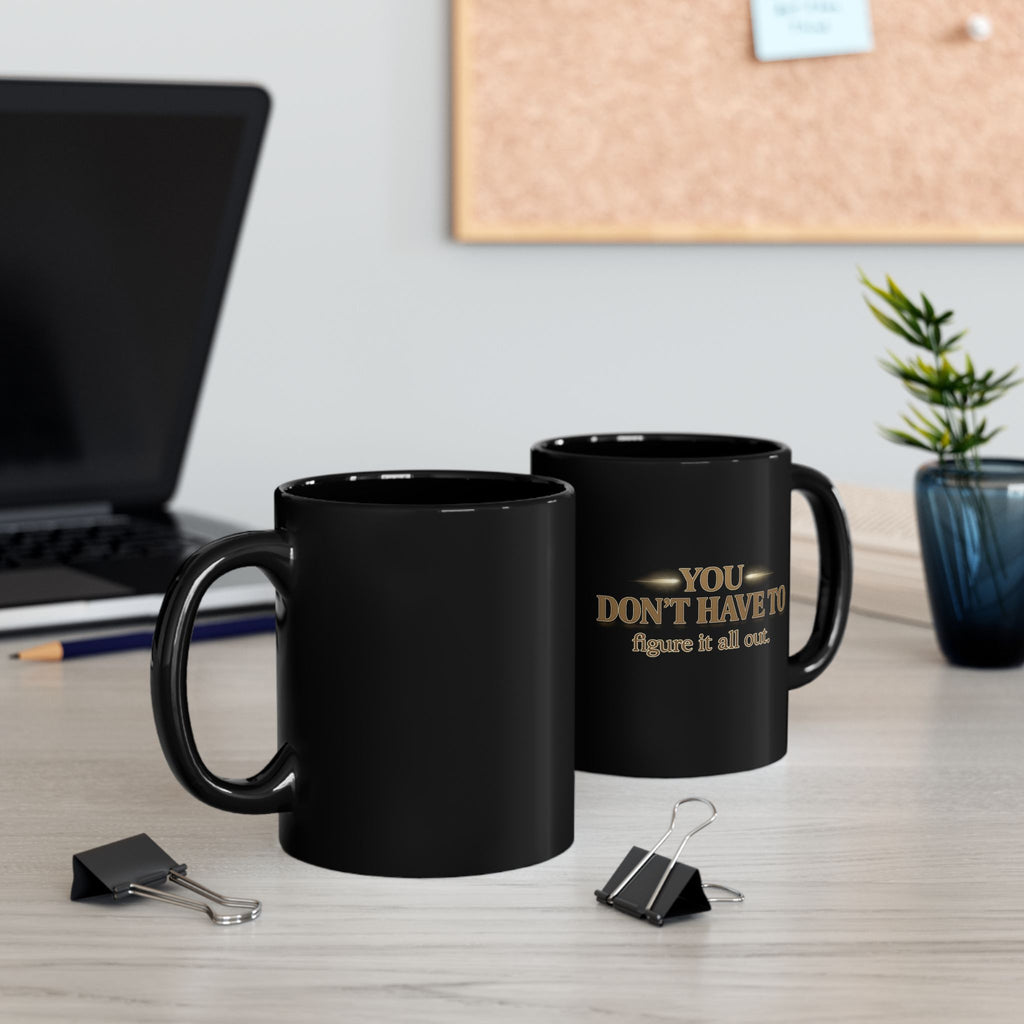 Christian faith coffee mug with inspirational text on a desk beside office supplies.